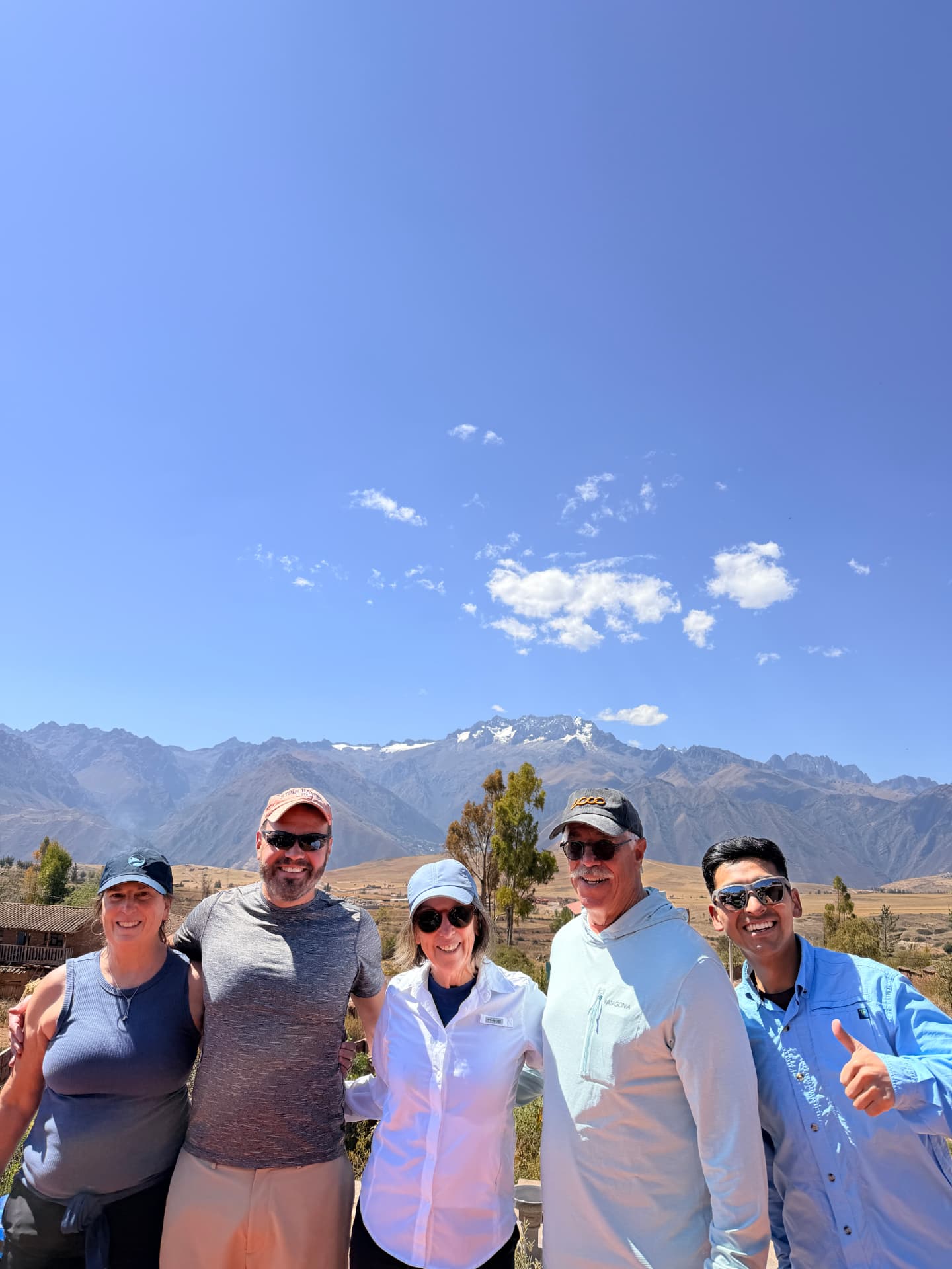 The group with their Backroads guide in front of snow-capped Andean peaks in the Sacred Valley