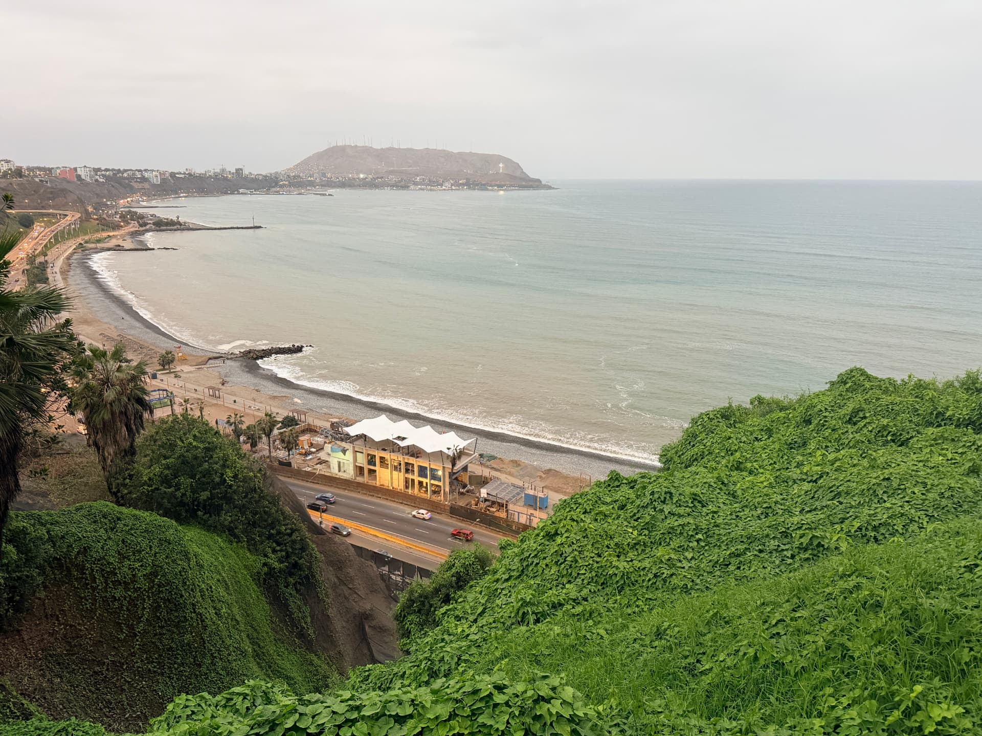 Miraflores coastline at dusk with the bay curving toward the headland